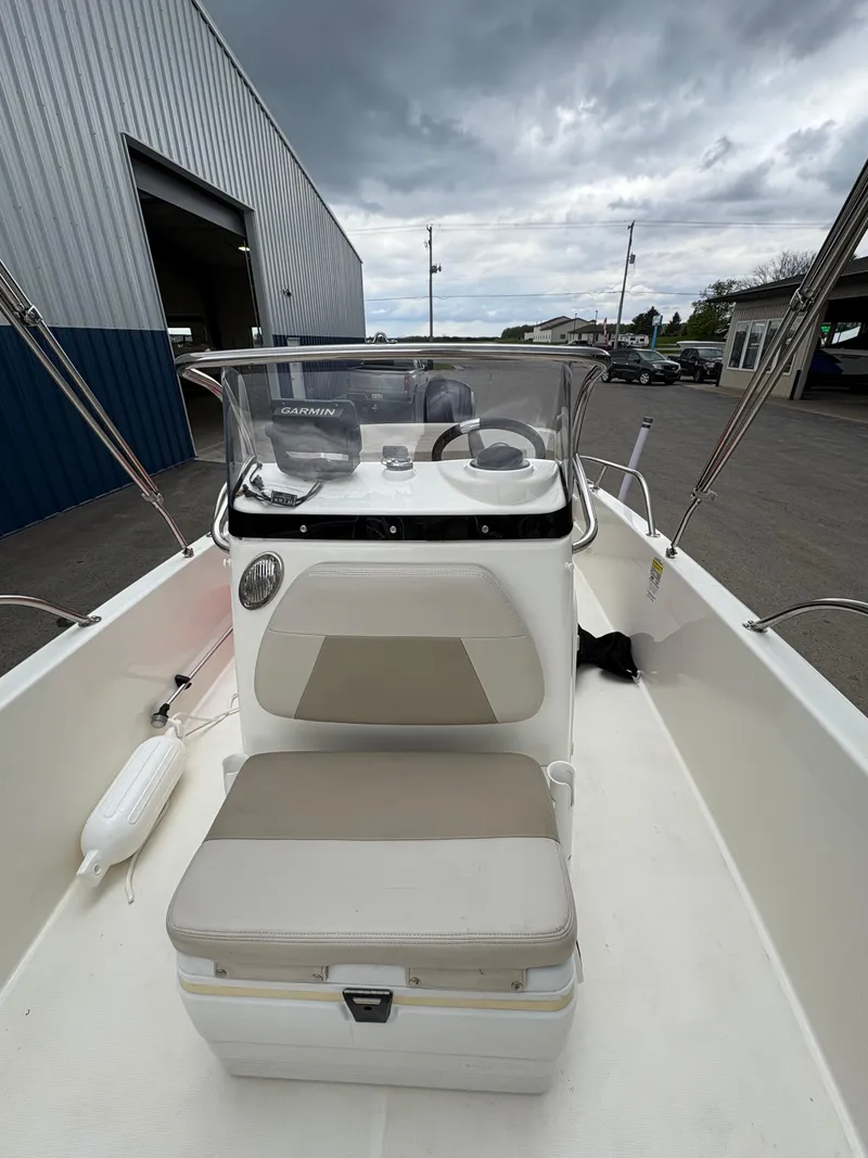Slide: The Image of 2019 Boston Whaler 170 Dauntless boat interior with console and seating. - 12