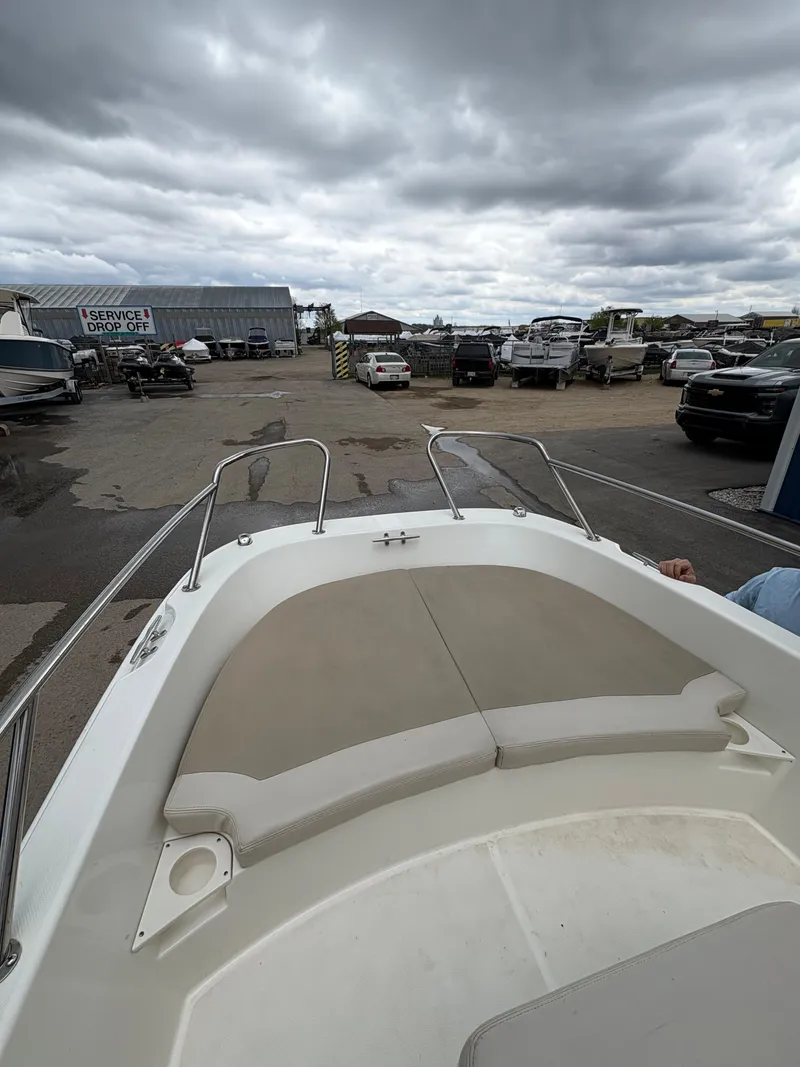 Slide: The Image of 2019 Boston Whaler 170 Dauntless boat at a service drop-off area under cloudy skies. - 13