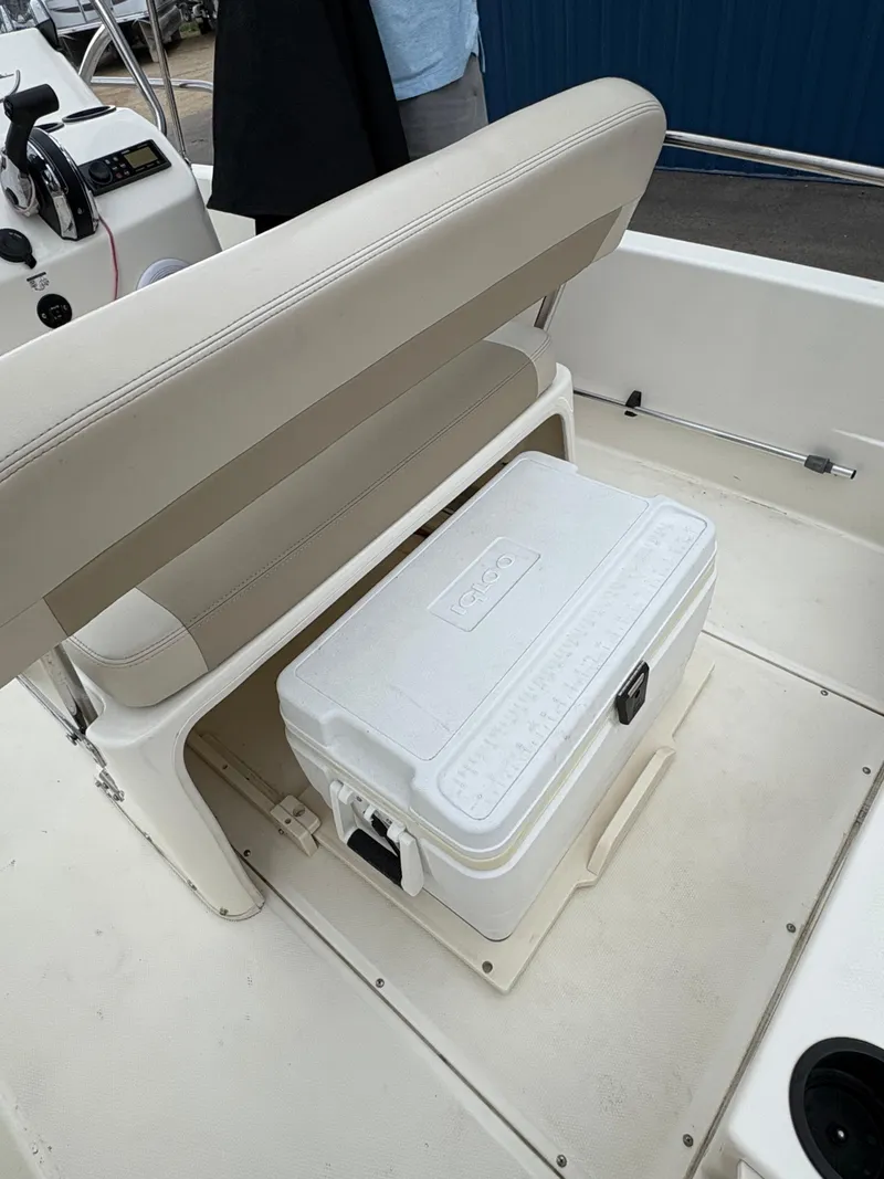 Slide: The Image of 2019 Boston Whaler 170 Dauntless boat interior with cooler under beige seat. - 16