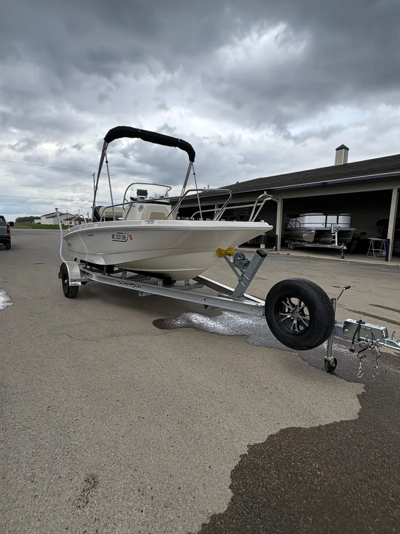 Slide: The Image of 2019 Boston Whaler 170 Dauntless boat on trailer under cloudy sky. - 5