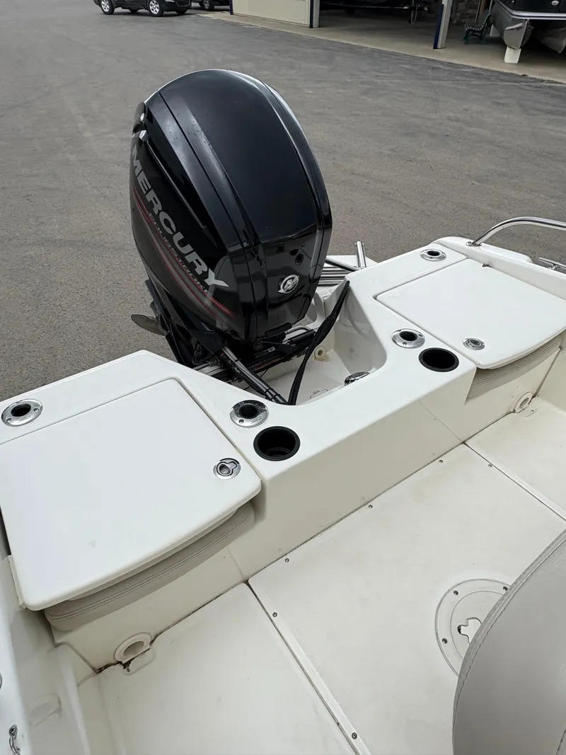 Slide: The Image of 2019 Boston Whaler 170 Dauntless boat with Mercury outboard motor, docked on pavement. - 6