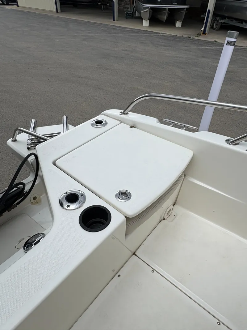 Slide: The Image of 2019 Boston Whaler 170 Dauntless boat interior with storage compartment and cup holders. - 7