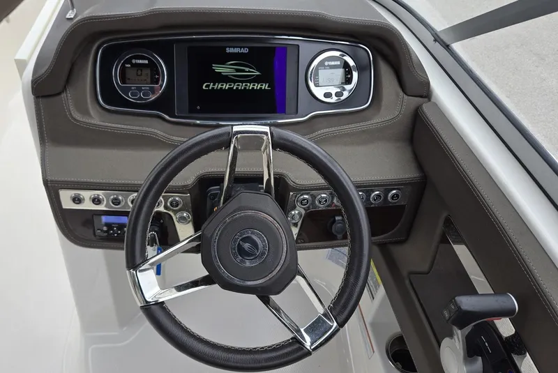 Slide: The Image of 2021 Chaparral 230 boat dashboard with steering wheel and digital display. - 10
