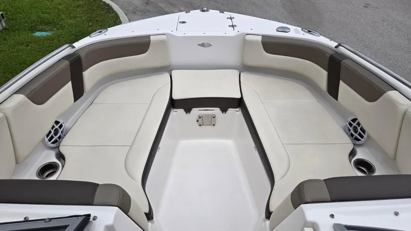 Slide: The Image of 2021 Chaparral 230 boat interior with spacious seating and cup holders. - 6