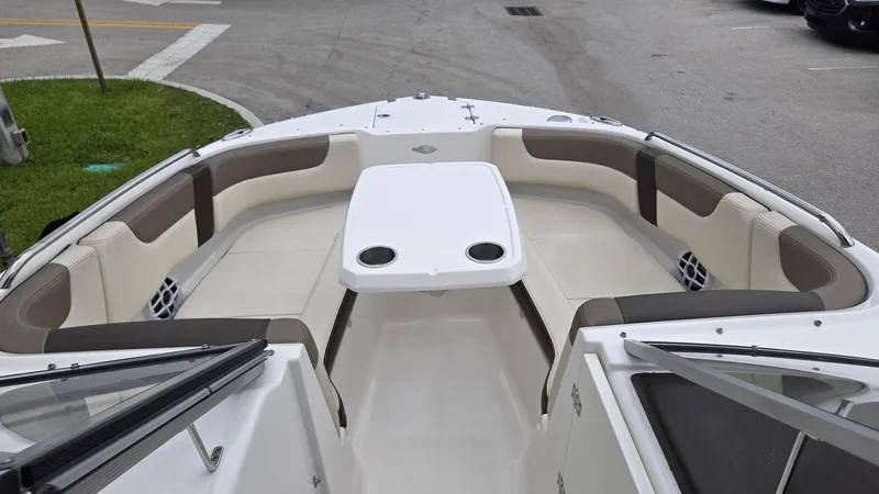 Slide: The Image of 2021 Chaparral 230 boat interior with spacious seating and table. - 7