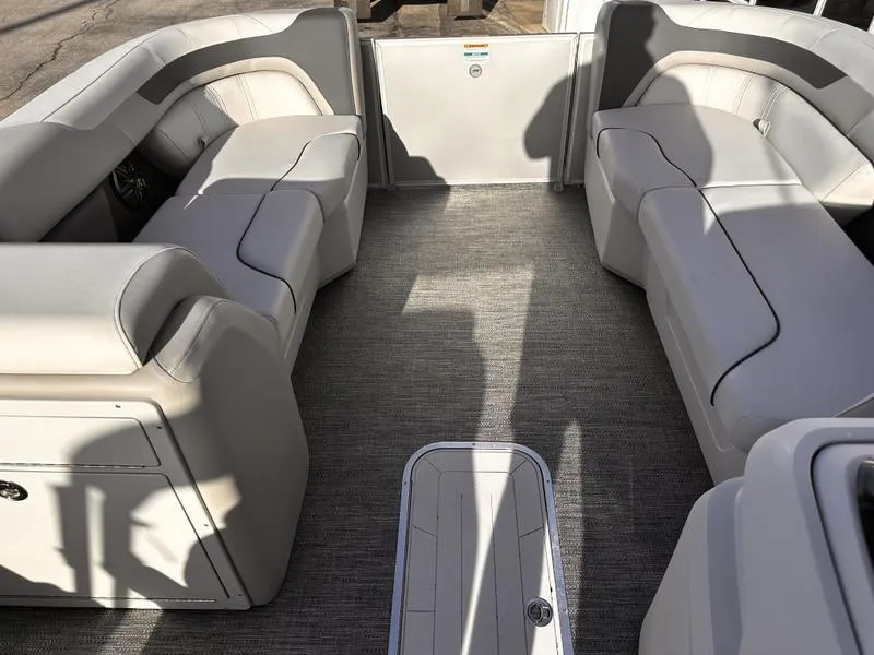 Slide: The Image of Interior of 2025 Godfrey Sweetwater 2286 SFLC pontoon boat with plush seating and carpeted floor. - 7