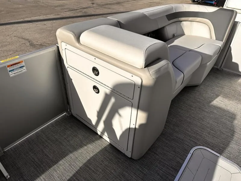 Slide: The Image of 2025 Godfrey Sweetwater 2286 SFLC boat interior with gray seating and storage compartment. - 8