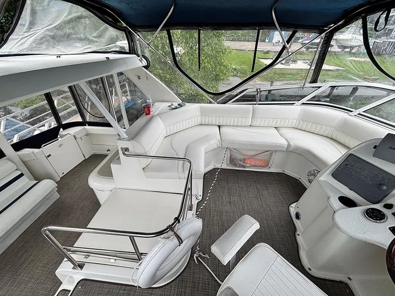 Slide: The Image of 2004 Cruisers Yachts 375 Motoryacht interior with white seating and helm station. - 12