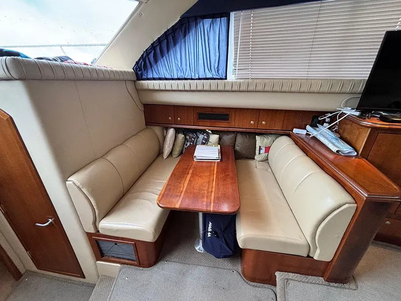 Slide: The Image of 2004 Cruisers Yachts 375 Motoryacht interior with beige seating and wooden table. - 27