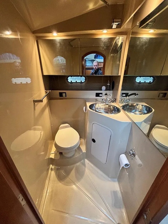 Slide: The Image of 2004 Cruisers Yachts 375 Motoryacht bathroom with modern fixtures and mirrored walls. - 34