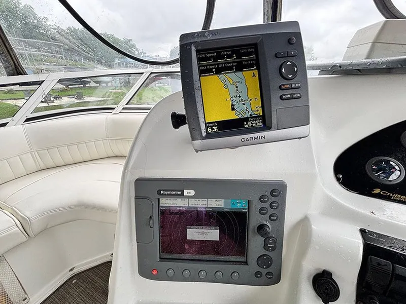 Slide: The Image of 2004 Cruisers Yachts 375 Motoryacht helm with Garmin and Raymarine navigation systems. - 35