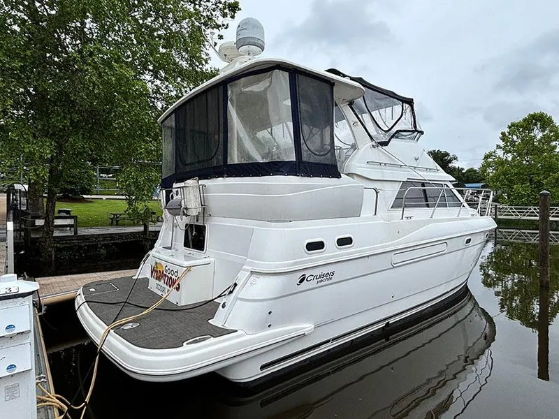 Slide: The Image of 2004 Cruisers Yachts 375 Motoryacht docked, featuring sleek design and spacious deck. - 4