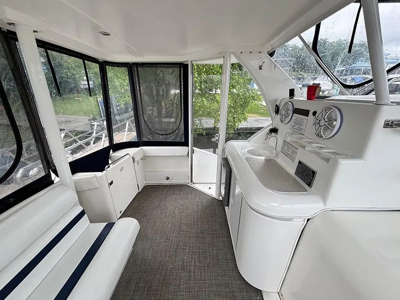Slide: The Image of 2004 Cruisers Yachts 375 Motoryacht interior with seating and helm, featuring modern design. - 7