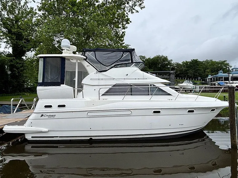 The Image of 2004 Cruisers Yachts 375 Motoryacht docked on calm water, side view. - 0