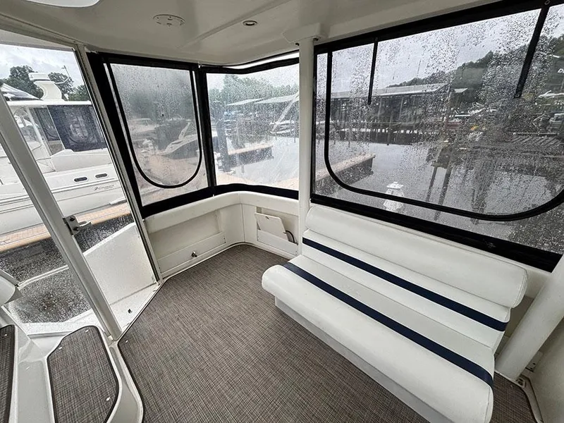 Slide: The Image of 2004 Cruisers Yachts 375 Motoryacht interior with white seating and large windows. - 10