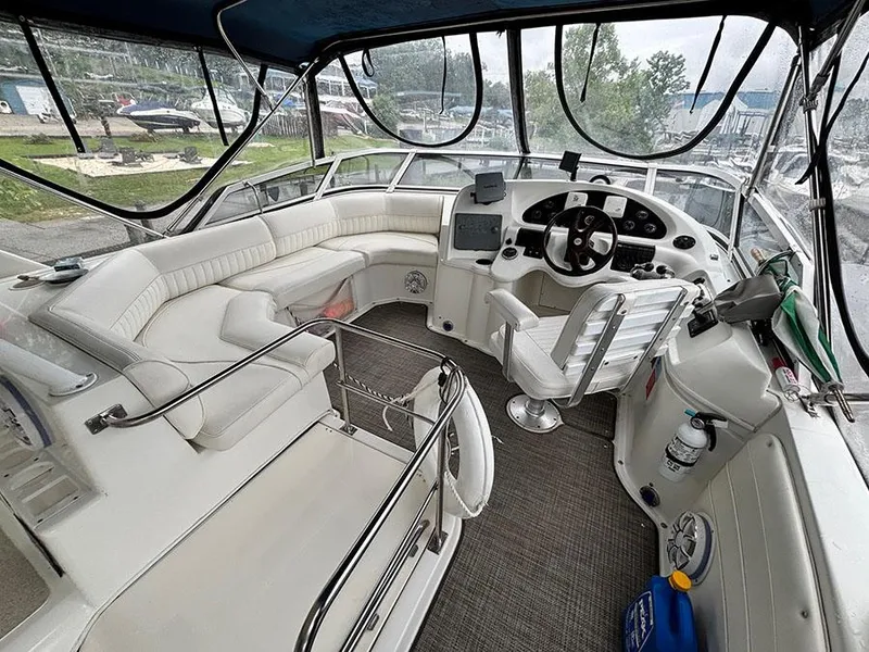 Slide: The Image of 2004 Cruisers Yachts 375 Motoryacht cockpit with white seating and navigation controls. - 11