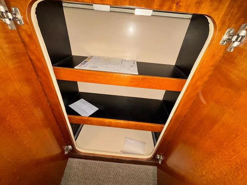 Slide: The Image of 2004 Cruisers Yachts 375 Motoryacht interior cabinet with shelves and documents. - 20