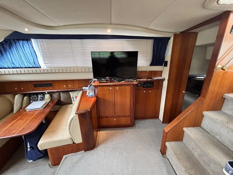 Slide: The Image of Interior of 2004 Cruisers Yachts 375 Motoryacht with TV, dining area, and stairs. - 24