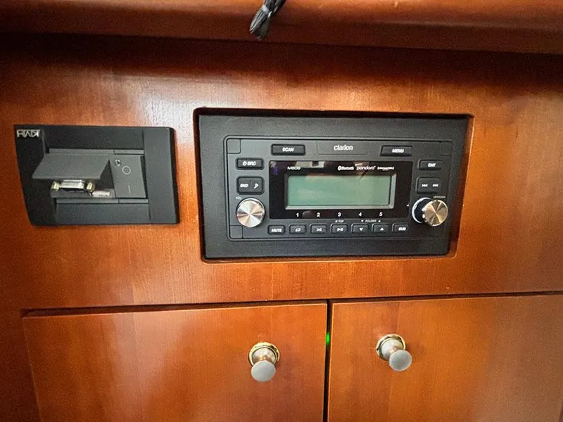 Slide: The Image of 2004 Cruisers Yachts 375 Motoryacht stereo system and control panel on wooden dashboard. - 25