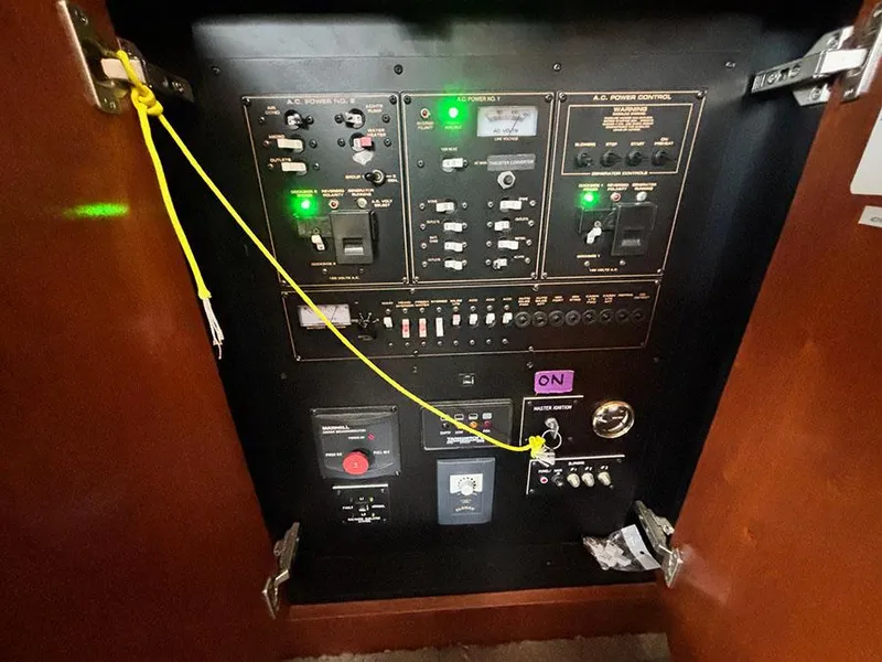 Slide: The Image of Electrical control panel inside 2004 Cruisers Yachts 375 Motoryacht, featuring switches and indicators. - 26
