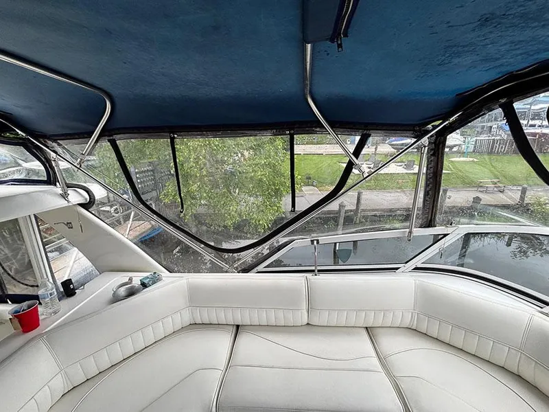 Slide: The Image of 2004 Cruisers Yachts 375 Motoryacht interior with white seating and blue canopy. - 41