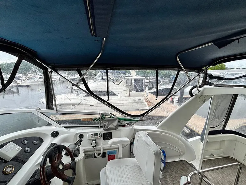 Slide: The Image of 2004 Cruisers Yachts 375 Motoryacht interior with helm, seating, and marina view. - 43