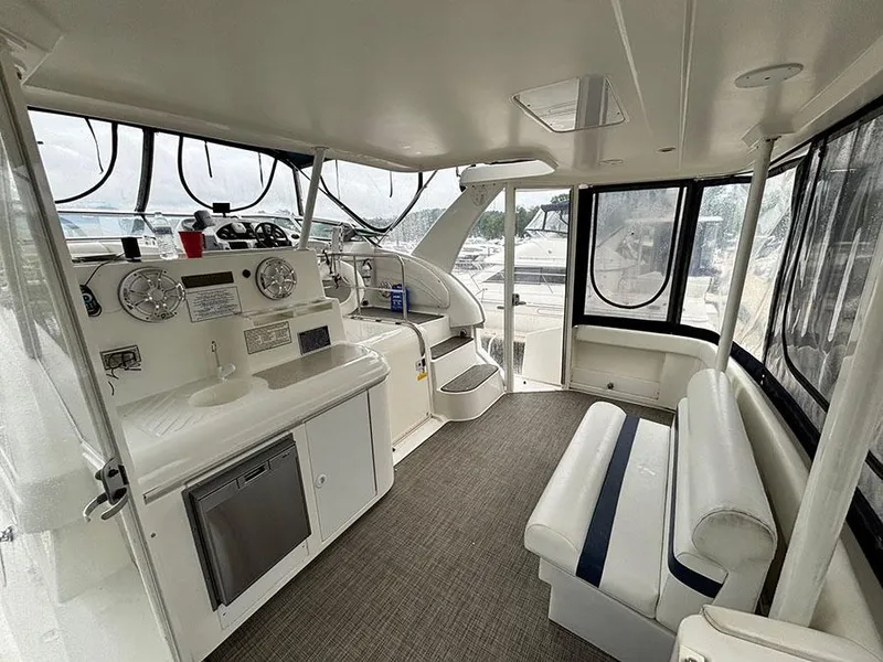 Slide: The Image of 2004 Cruisers Yachts 375 Motoryacht interior with helm, seating, and panoramic windows. - 6