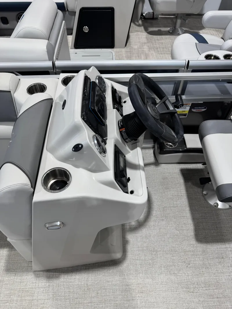 Slide: The Image of 2024 Avalon 2385 25 Venture 85 QL boat interior with steering console and seating. - 5