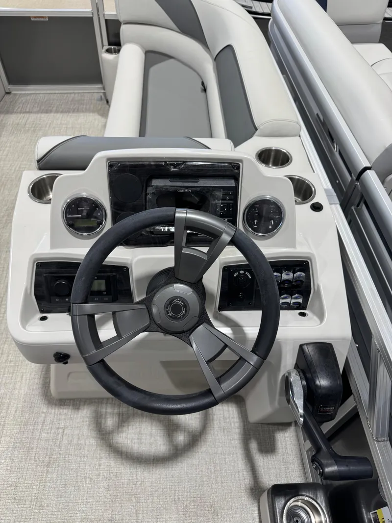 Slide: The Image of 2024 Avalon 2385 25 Venture 85 QL boat dashboard with steering wheel and controls. - 6