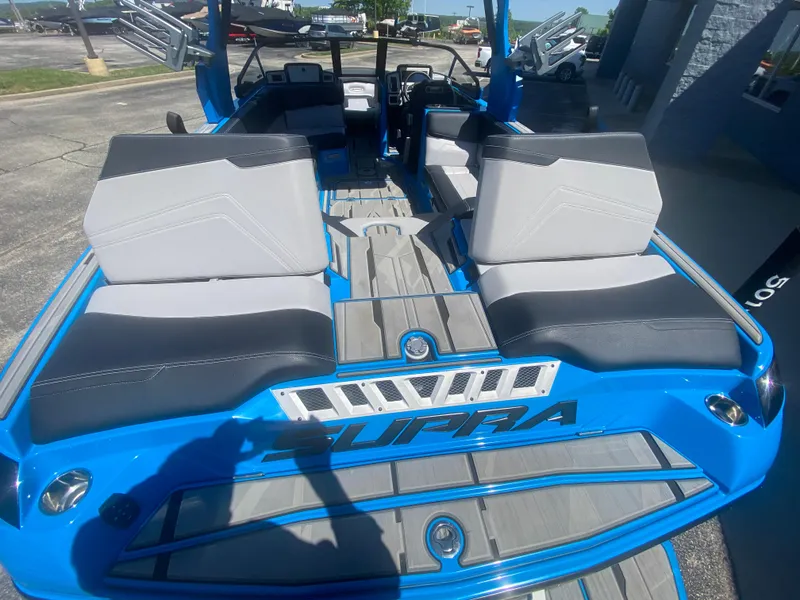 Slide: The Image of 2021 Supra SL 450 boat interior with blue and gray seating. - 12
