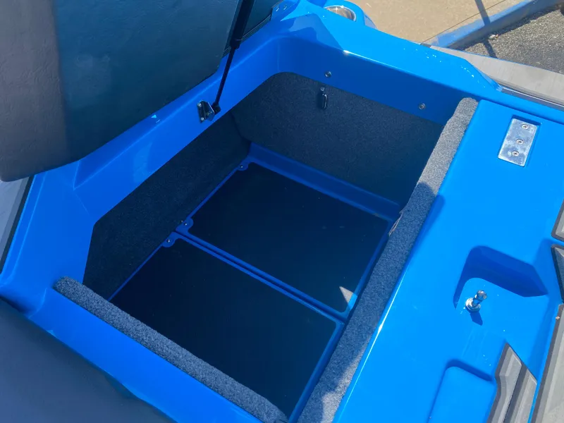 Slide: The Image of 2021 Supra SL 450 boat storage compartment, open, with blue interior and gray lining. - 13