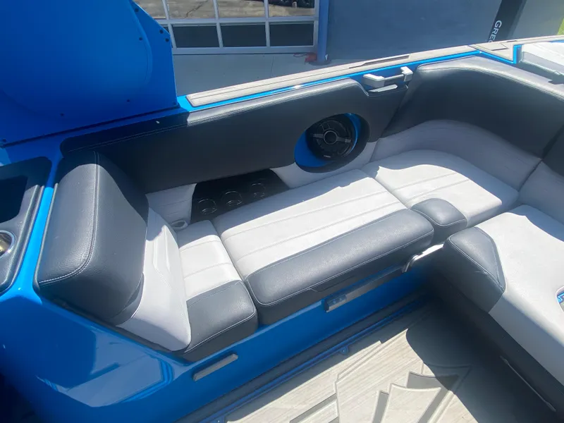 Slide: The Image of 2021 Supra SL 450 boat interior with blue and white seating. - 17