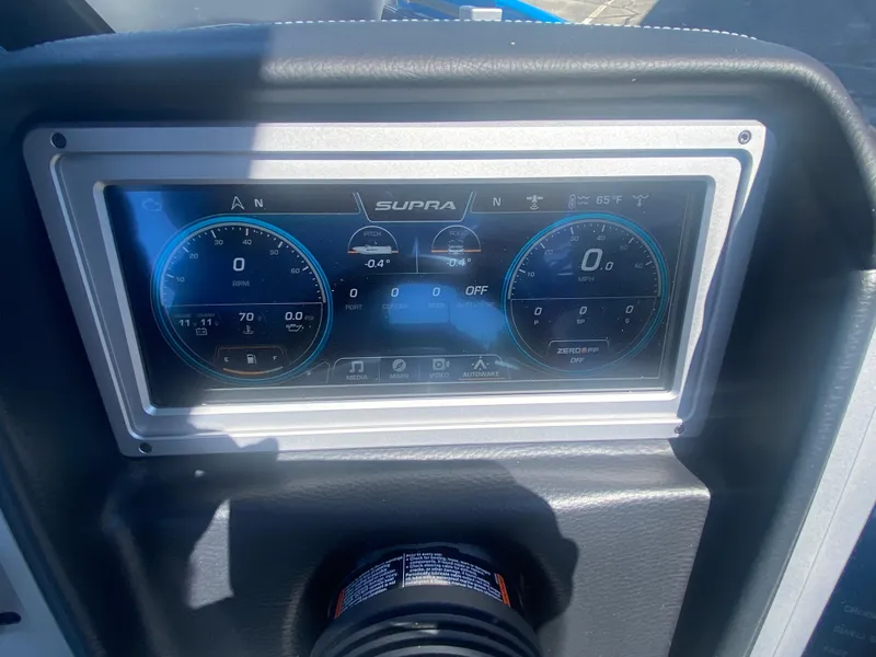 Slide: The Image of Dashboard of a 2021 Supra SL 450 boat with digital display gauges. - 18