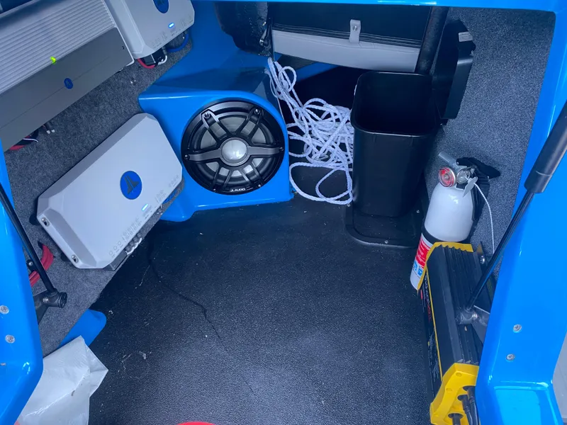 Slide: The Image of Interior of a 2021 Supra SL 450 with speaker, fire extinguisher, and equipment. - 26