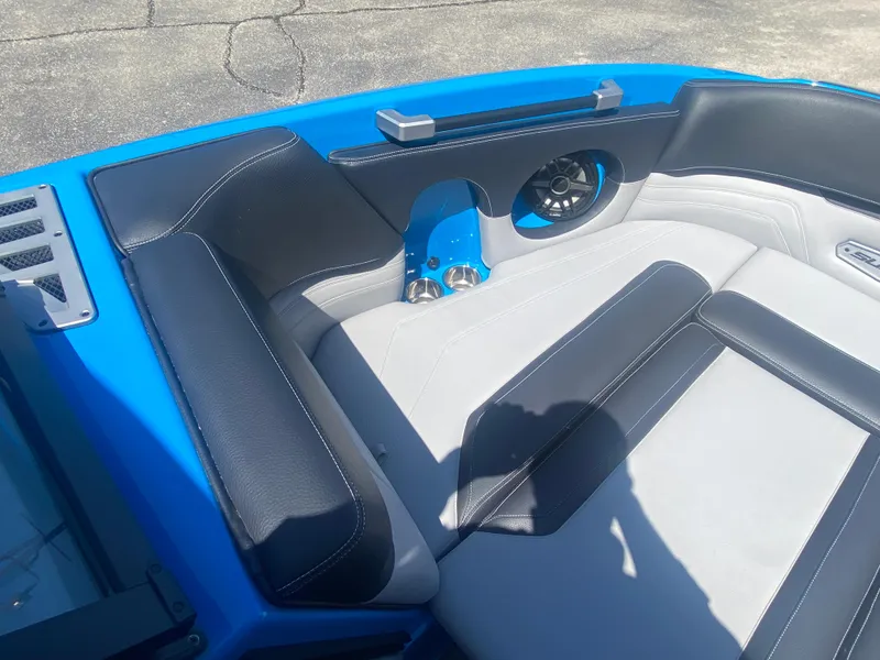 Slide: The Image of 2021 Supra SL 450 boat interior with blue and black seating, speaker, and cup holders. - 30