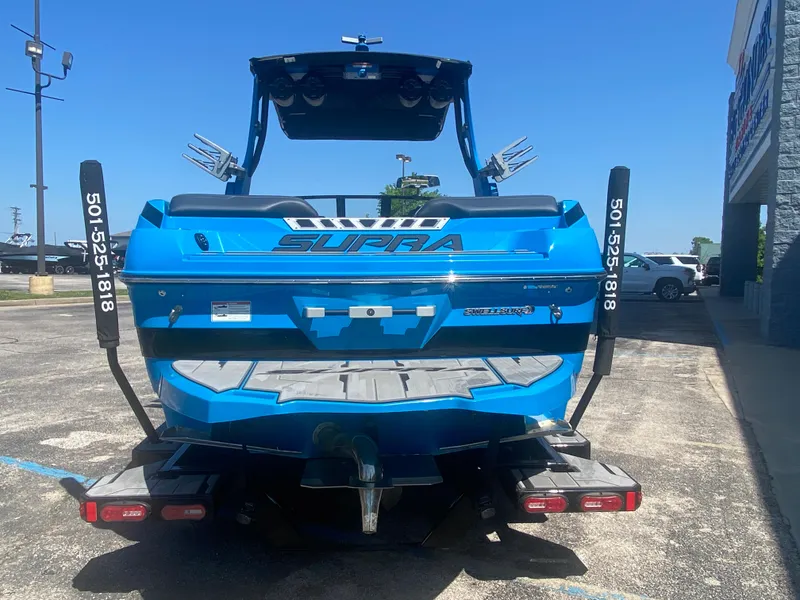 Slide: The Image of Blue 2021 Supra SL 450 boat parked outdoors, rear view. - 4