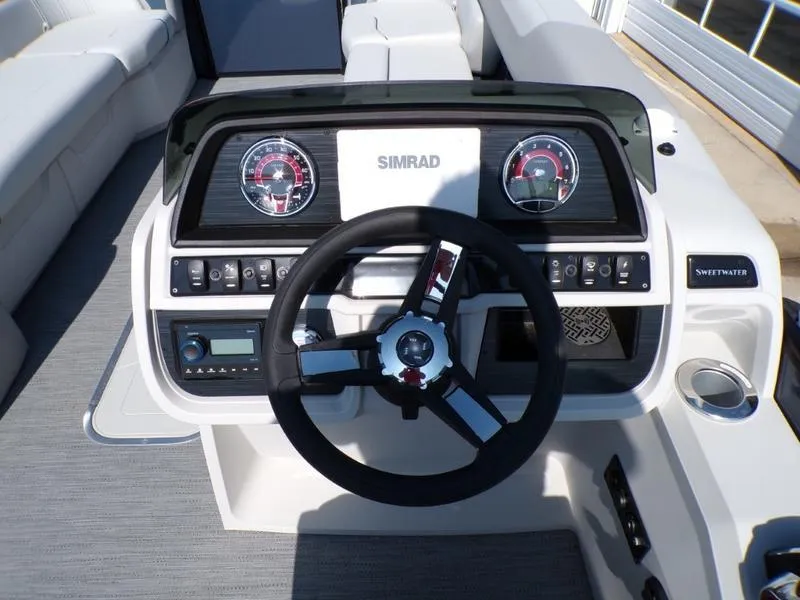 Slide: The Image of 2025 Godfrey Sweetwater 2486 QS iMPACT boat dashboard with steering wheel and controls. - 12