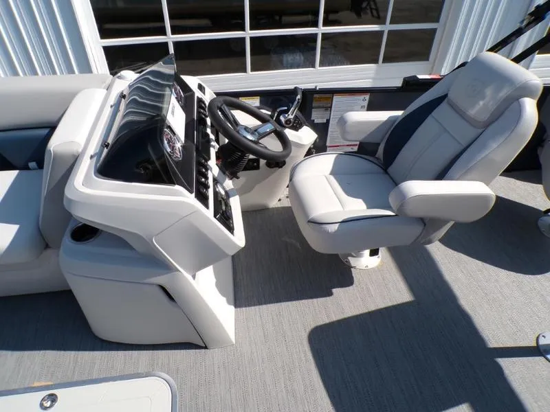 Slide: The Image of 2025 Godfrey Sweetwater 2486 QS iMPACT boat helm with steering wheel and captain's chair. - 13