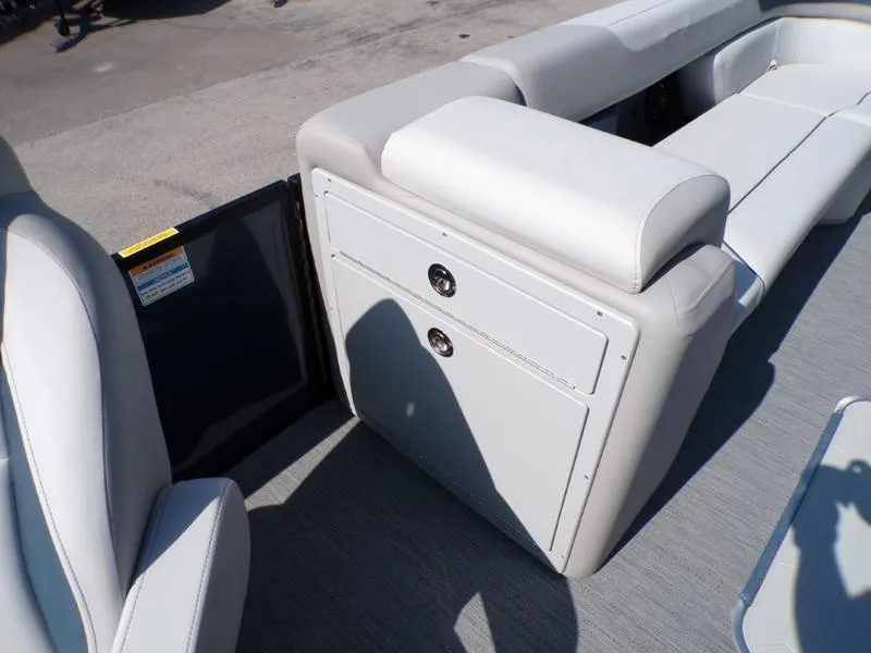 Slide: The Image of 2025 Godfrey Sweetwater 2486 QS iMPACT pontoon boat interior with plush seating and storage. - 15