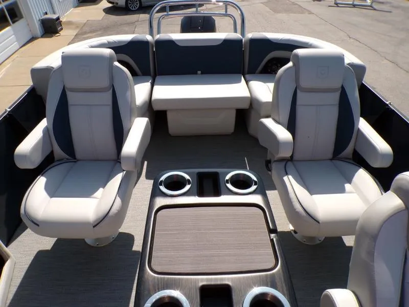 Slide: The Image of 2025 Godfrey Sweetwater 2486 QS iMPACT pontoon boat interior with plush seating and cup holders. - 8