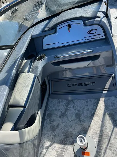Slide: The Image of 2023 Crest Continental 250 boat interior with sleek dashboard and seating. - 12