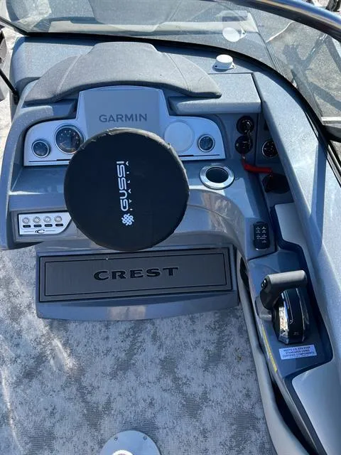 Slide: The Image of 2023 Crest Continental 250 boat dashboard with Garmin system and steering wheel. - 13