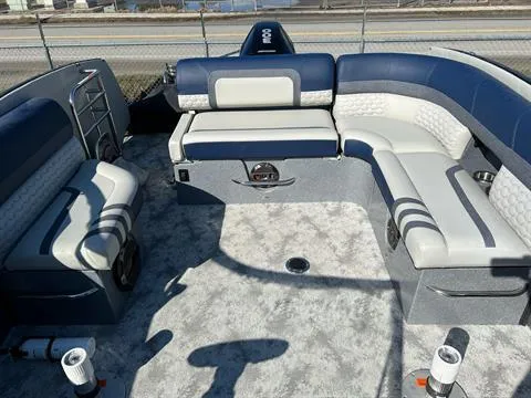 Slide: The Image of 2023 Crest Continental 250 boat interior with blue and white seating, spacious layout. - 15