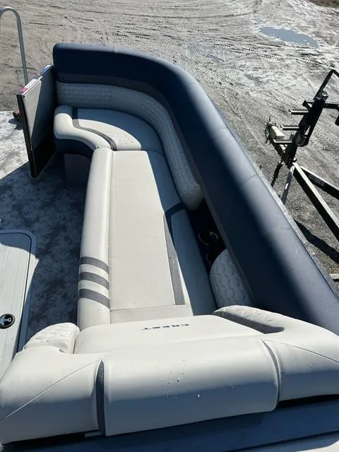 Slide: The Image of 2023 Crest Continental 250 boat interior with curved seating and modern design. - 16