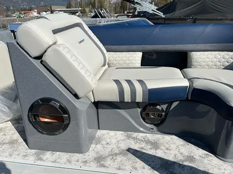 Slide: The Image of 2023 Crest Continental 250 boat interior with cushioned seating and built-in speakers. - 19