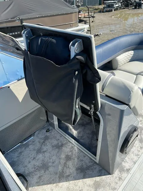 Slide: The Image of 2023 Crest Continental 250 boat interior with storage compartment and seating. - 22