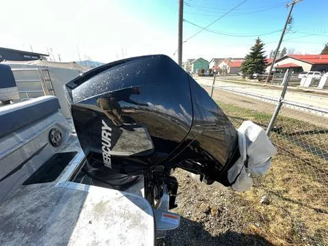 Slide: The Image of 2023 Crest Continental 250 boat with Mercury outboard motor, parked outdoors. - 24