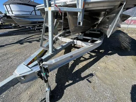 Slide: The Image of 2023 Crest Continental 250 boat on a trailer, parked on gravel. - 26
