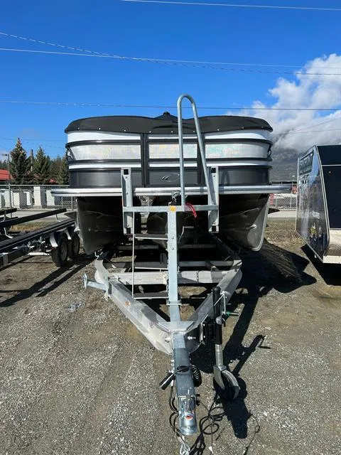 Slide: The Image of 2023 Crest Continental 250 boat on trailer under clear blue sky. - 5