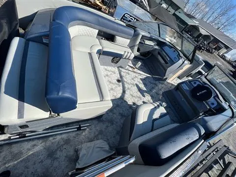 Slide: The Image of 2023 Crest Continental 250 boat interior with blue and white seating, steering console, and open deck. - 8